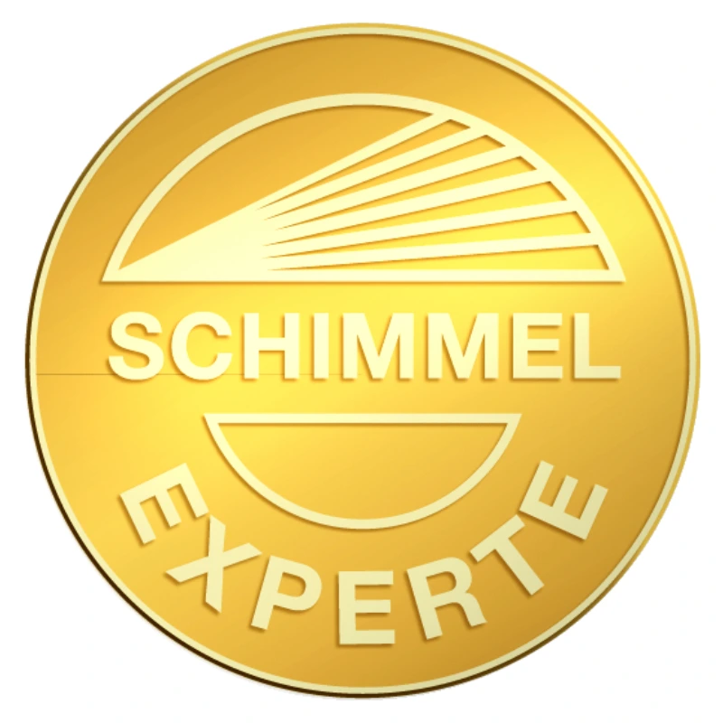 Eine glänzende Goldmünze mit der Aufschrift "Schimmel Experte". Die Münze hat ein elegantes Design und strahlt Professionalität aus, was das Vertrauen in den Expertenstatus symbolisiert.