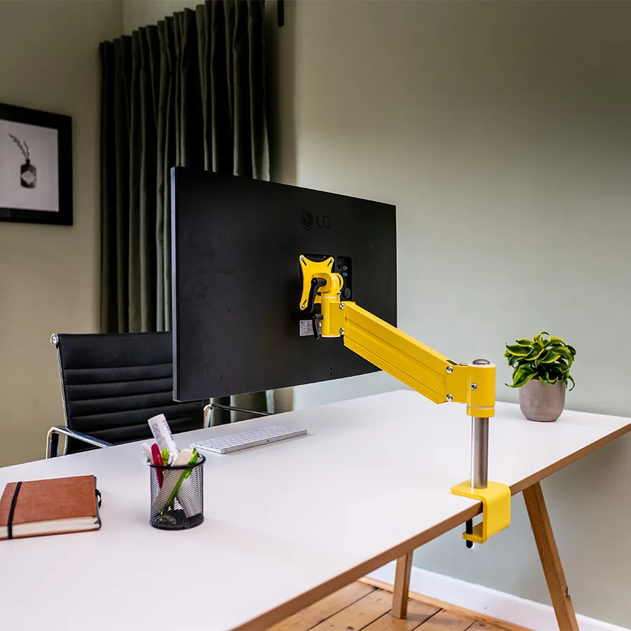 TFT-Lift Halterung in Gelb mit einem Monitor, ergonomisch verstellbar für eine bequeme Arbeitsplatzgestaltung.